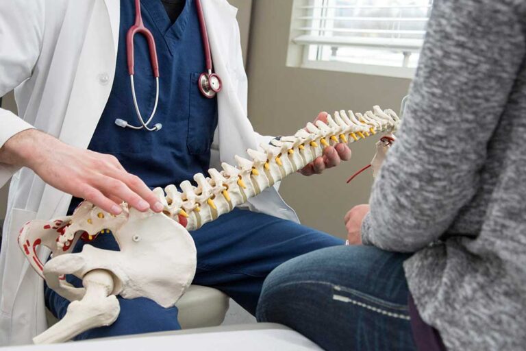 Person seated at home gently stretching the neck and shoulders beside a desk